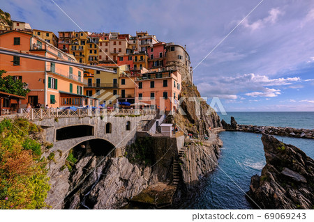 Colorful traditional houses on the rock over Mediterranean sea, Manarola, Cinque Terre, Italy Colorful traditional houses on the rock over Mediterranean sea, Manarola, Cinque Terre, Italy 69069243