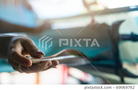 Woman working on weaving machine for weave handmade fabric. Text 69069762