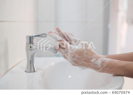 Woman washing hands, Corona virus travel prevention wash hands with soap and hot water. Hand hygiene for coronavirus outbreak. Protection by washing hands frequently concept. Woman washing hands, Corona virus travel prevention wash hands with soap and hot water. Hand hygiene for coronavirus outbreak. Protection by washing hands frequently concept. 69070974