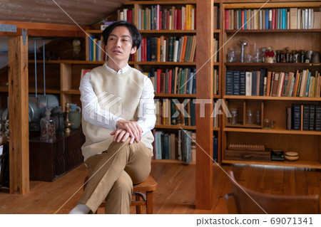 Autumn in reading: a young literary man relaxing in the attic 69071341