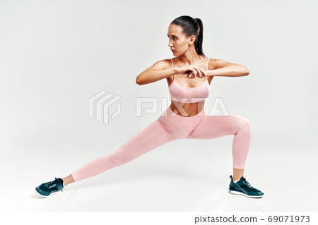 Sporty woman doing warm up and stretch legs Sporty woman doing warm up and stretch legs 69071973