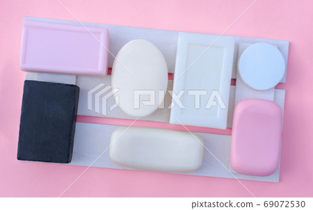 pink, white and black soap bars on a wooden tray pink, white and black soap bars on a wooden tray 69072530
