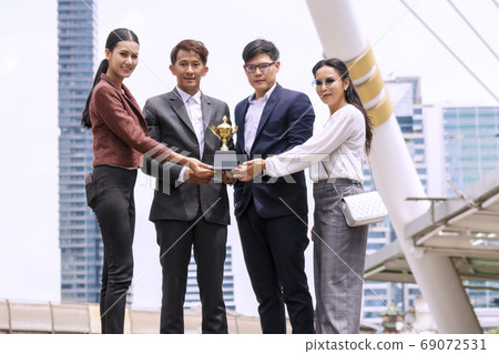 Group of business people raise hands holding Group of business people raise hands holding 69072531