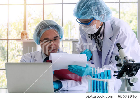 Young asian woman and senior man researcher 69072980