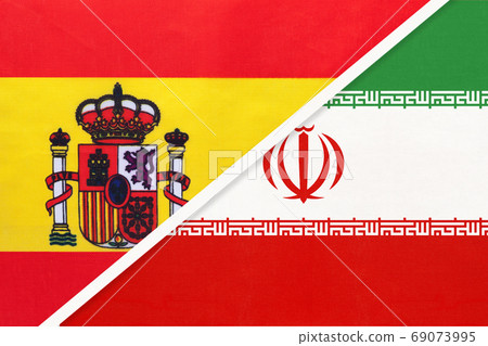 Spain and Iran or Persia, symbol of two national flags from textile. Partnership between European and Asian countries. Spain and Iran or Persia, symbol of two national flags from textile. Partnership between European and Asian countries. 69073995