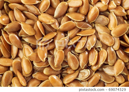 Flax seed is a good source of omega-3 fatty acids, and is used to make linseed oil. Macro photo. texture Flax seed is a good source of omega-3 fatty acids, and is used to make linseed oil. Macro photo. texture 69074329