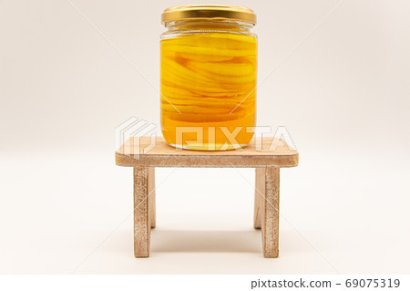 Bottled honey lemon on a table Bottled honey lemon on a table 69075319