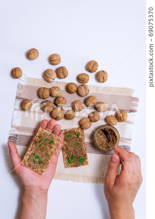 Walnut butter and fresh nuts on table. Copy space for text. vertical photo Walnut butter and fresh nuts on table. Copy space for text. vertical photo 69075370