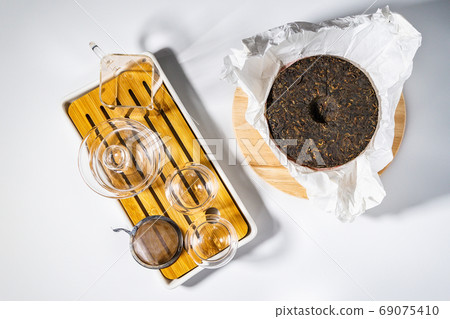 Chinese pressed PU-erh tea, pressed tea top view of a flat lay. Sheng Puer and Shu Puer Chinese pressed PU-erh tea, pressed tea top view of a flat lay. Sheng Puer and Shu Puer 69075410
