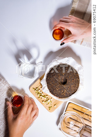 Chinese Puer tea ceremony on a white background, a man and a woman drink tea. top view flat lay Chinese Puer tea ceremony on a white background, a man and a woman drink tea. top view flat lay 69075412