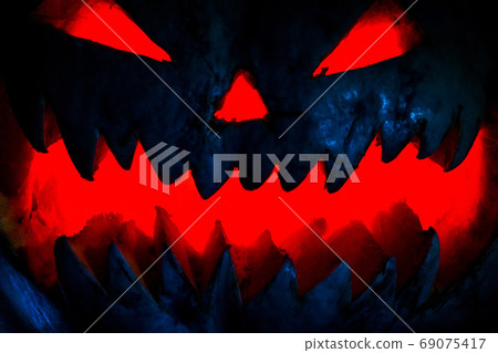 Scary smiling Halloween pumpkin on dark background. retro style, noise, selective focus 69075417