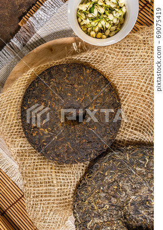 pressed puer tea top view. Chinese puer shu and shen in the form of pancakes. top view, vertical photo pressed puer tea top view. Chinese puer shu and shen in the form of pancakes. top view, vertical photo 69075419
