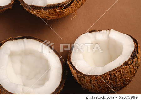 Coconut fruits on brown plain background 69075989