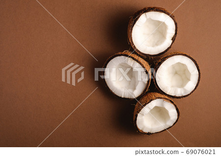 Coconut fruits on brown plain background 69076021