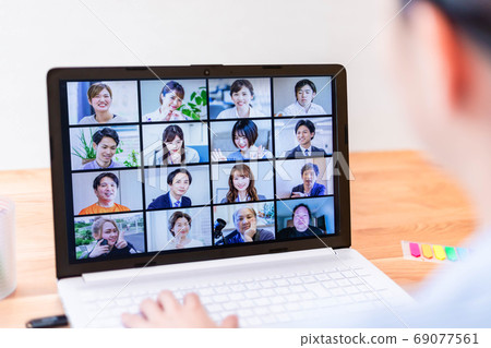 Young female employee attending an online meeting Young female employee attending an online meeting 69077561