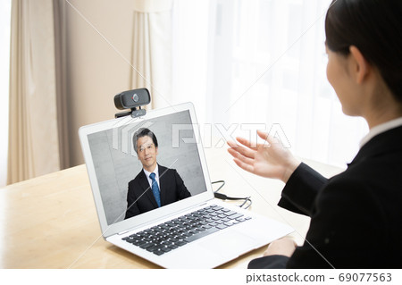 Young woman taking an online interview at home 69077563