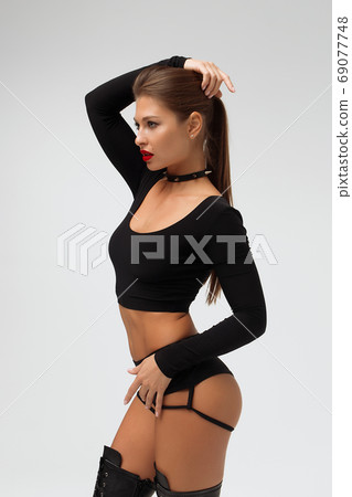 Alluring young woman in black underwear and boots 69077748