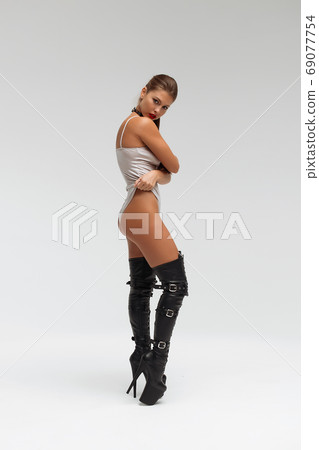 Alluring young woman in black underwear and boots 69077754