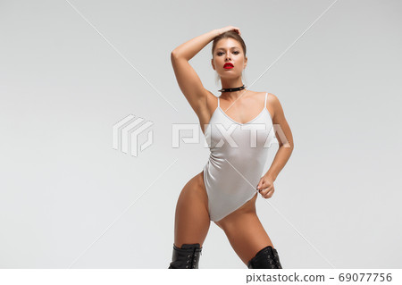 Alluring young woman in black underwear and boots 69077756