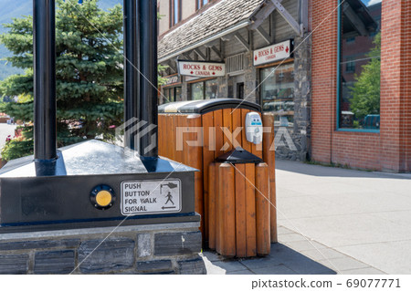 Sidewalk button on street of Banff avenue during covid-19 pandemic period. Banff, Canada. 69077771