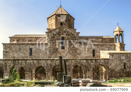 View of the Odzun monastery with arched gallery and medieval cemetery at sunset View of the Odzun monastery with arched gallery and medieval cemetery at sunset 69077909