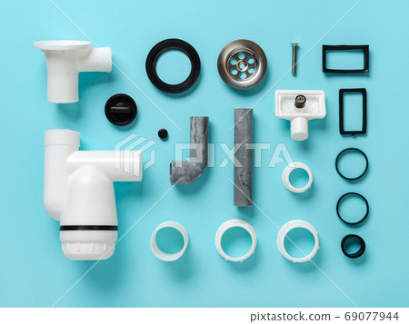 Sink waste water trap parts knolled on a blue background. Sink waste water trap parts knolled on a blue background. 69077944