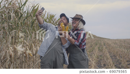 Farmers taking selfie with corn 69079365