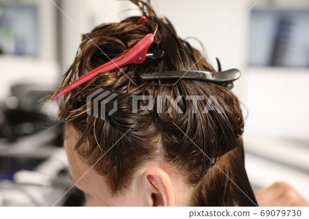 Women's wet hair with different hairpins closeup Women's wet hair with different hairpins closeup 69079730