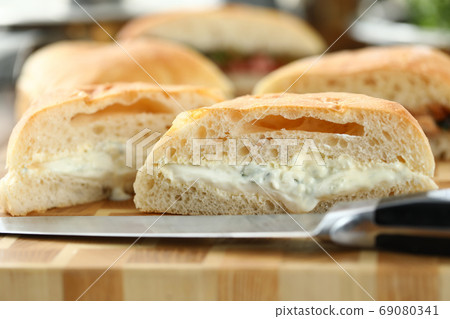 Lot of burger and knife, cut in half, lay on cutting board. Lot of burger and knife, cut in half, lay on cutting board. 69080341