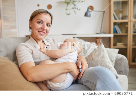 Happy Mom Cuddling Baby 69080771