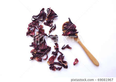 Red dried hibiscus flower leaves in a little wooden spoon, floral tea healthy drink, eco-friendly concept 69081967
