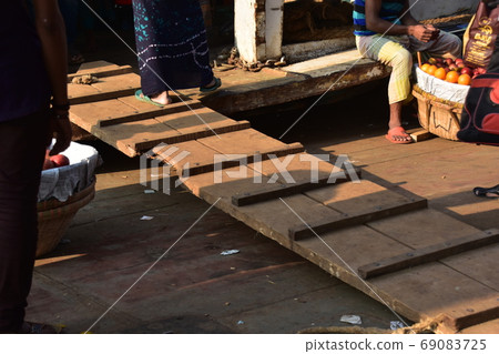 A Bangladeshi man working at a pier on a ship docked in Dhaka Shodorgat, Bangladesh 69083725