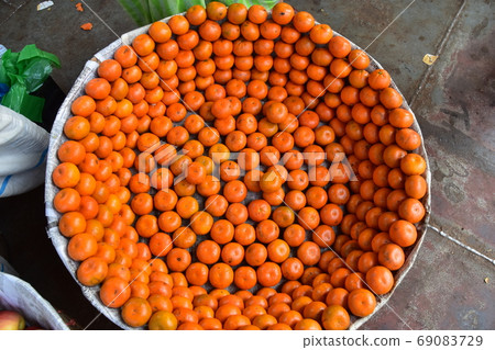 Dhaka in Bangladesh Fruit stalls for sale at Shodorgut Many oranges neatly arranged in a basket 69083729