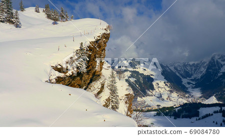 Flight over a snowy mountains in winter - wonderful Swiss Alps Flight over a snowy mountains in winter - wonderful Swiss Alps 69084780