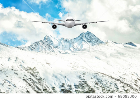 Airplane frying over the Snow Mountain background 69085300
