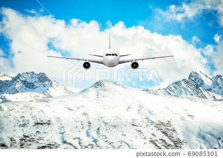 Airplane frying over the Snow Mountain background 69085301