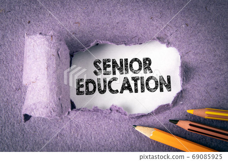 SENIOR EDUCATION concept. Text under torn paper SENIOR EDUCATION concept. Text under torn paper 69085925
