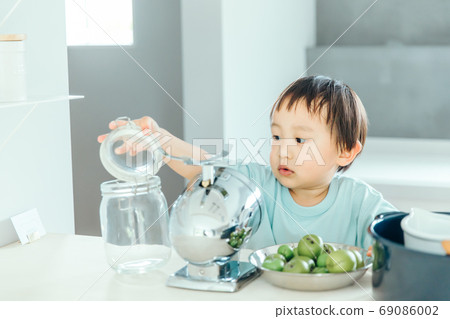 A little boy helping cook in the kitchen boy kids kitchen 69086002