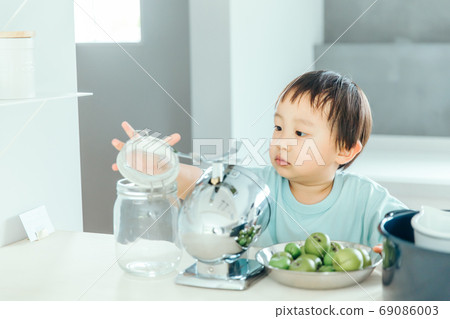 A little boy helping cook in the kitchen boy kids kitchen 69086003