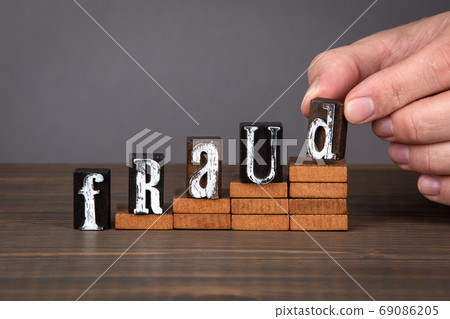 FRAUD concept. Wooden alphabet letters on steps FRAUD concept. Wooden alphabet letters on steps 69086205