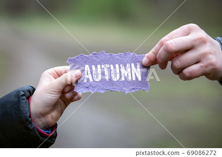 AUTUMN. Mother and child holding a note sheet AUTUMN. Mother and child holding a note sheet 69086272