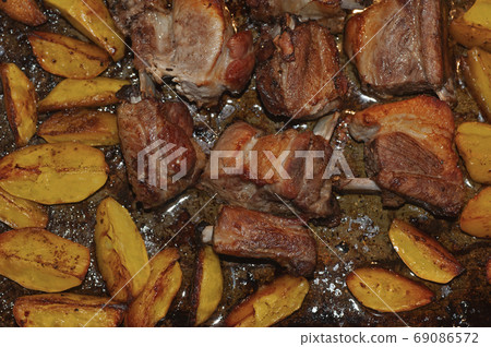 photo of baked pork ribs and potatoes in oil and paprika photo of baked pork ribs and potatoes in oil and paprika 69086572