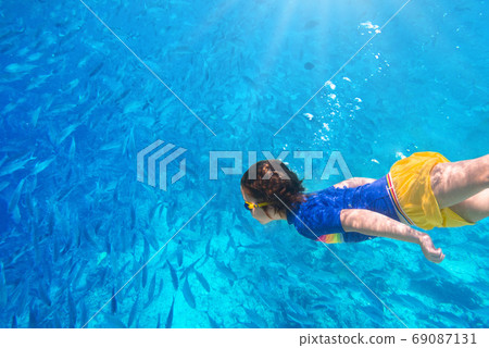 Child snorkeling. Kids underwater. Beach and sea. Child snorkeling. Kids underwater. Beach and sea. 69087131