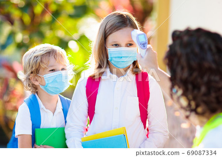 Temperature check at school. Child in mask. 69087334