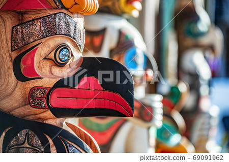 Alaska totem pole carving art sculture store in tourist travel attraction town on Alaska cruise. Ketchikan, Juneau, Skagway stores and shops selling native paintings and art. 69091962