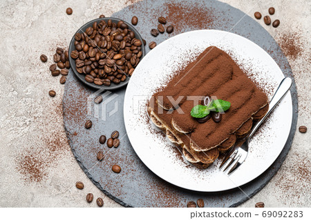 Classic tiramisu dessert on ceramic plate on concrete background 69092283