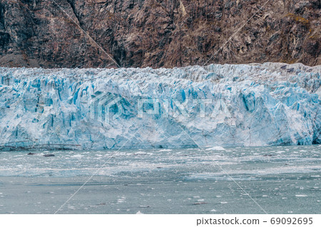 Alaska glacier front in Glacier Bay National Park. Blue Ice global warming. USA travel destination. Alaska glacier front in Glacier Bay National Park. Blue Ice global warming. USA travel destination. 69092695