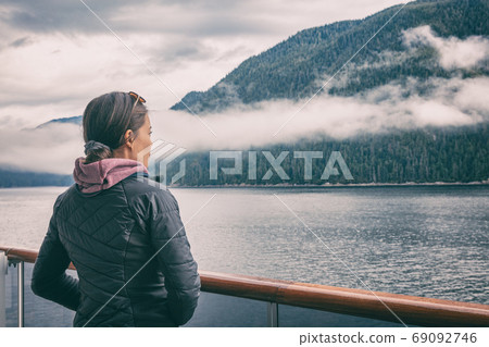 Alaska inside passage cruise tourist woman in Misty Fjords near Ketchikan, Alaskan famous landmark attraction. Scenic cruising in North America. 69092746