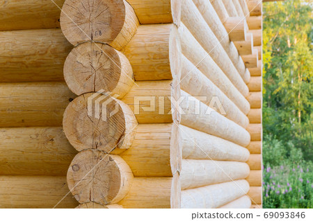 corner of wooden house made of natural logs 69093846