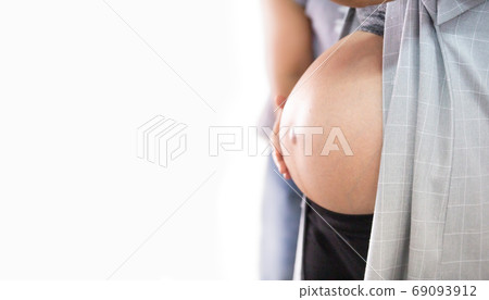 pregnant woman holding her belly pregnant woman holding her belly 69093912
